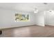 Bright living room with hardwood floors and a large window overlooking the greenery outside at 807 Scrub Oak St, South Daytona, FL 32119