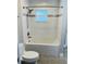 Clean bathroom has a white tiled shower/tub with white fixtures and gray accent tiles at 992 Shockney Dr, Ormond Beach, FL 32174