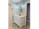 Bright bathroom features an updated vanity, designer mirror, and tile accents at 992 Shockney Dr, Ormond Beach, FL 32174