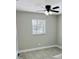Bright bedroom has a window, ceiling fan, and neutral color palette at 992 Shockney Dr, Ormond Beach, FL 32174