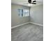 Bedroom features modern gray flooring, neutral walls, and lots of natural light at 992 Shockney Dr, Ormond Beach, FL 32174