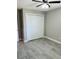 Clean bedroom features neutral walls, modern gray flooring, and a large closet at 992 Shockney Dr, Ormond Beach, FL 32174
