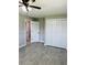 Spacious bedroom features closet, gray tile floors, and neutral paint at 992 Shockney Dr, Ormond Beach, FL 32174