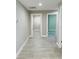Bright hallway featuring modern gray flooring and neutral paint at 992 Shockney Dr, Ormond Beach, FL 32174