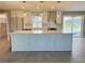 Bright and spacious kitchen featuring white cabinets, quartz countertops, and tile flooring at 992 Shockney Dr, Ormond Beach, FL 32174