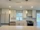 Well-appointed kitchen with stainless steel appliances and stylish pendant lighting at 992 Shockney Dr, Ormond Beach, FL 32174