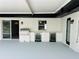 Covered patio features an outdoor kitchen with a built-in grill and cooler at 992 Shockney Dr, Ormond Beach, FL 32174