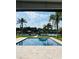 Beautiful pool with waterfront views, palm trees, and a boat dock for serene outdoor living at 992 Shockney Dr, Ormond Beach, FL 32174