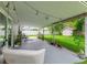 Covered back patio with ample seating and decorative hanging lights at 1719 Anniston Ave, Daytona Beach, FL 32117