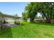 Expansive backyard with green grass and a covered patio area at 1719 Anniston Ave, Daytona Beach, FL 32117