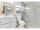 Bright bathroom with a glass enclosed shower and a vanity with a framed mirror at 1719 Anniston Ave, Daytona Beach, FL 32117