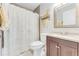 Bathroom featuring a vanity with granite counter, decorative shower curtain, and modern fixtures at 1719 Anniston Ave, Daytona Beach, FL 32117