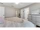Neutral toned bedroom with a ceiling fan and decoratively staged shelves and dresser at 1719 Anniston Ave, Daytona Beach, FL 32117