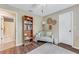 Comfortable bedroom with a cozy chair, bookcase and adjoining bathroom at 1719 Anniston Ave, Daytona Beach, FL 32117