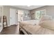 Bedroom featuring a wooden bed frame, hardwood floors, and an ensuite bathroom at 1719 Anniston Ave, Daytona Beach, FL 32117