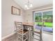 Bright dining area with a wood table and chairs, adjacent to a sliding glass door to the backyard at 1719 Anniston Ave, Daytona Beach, FL 32117