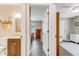 Hallway view towards the bathroom and bedroom featuring wood flooring at 1719 Anniston Ave, Daytona Beach, FL 32117