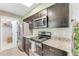Kitchen featuring granite countertops, stainless steel appliances and plenty of cabinet storage at 1719 Anniston Ave, Daytona Beach, FL 32117