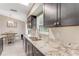 Bright kitchen featuring granite countertops, stainless steel appliances, and a view into the dining area at 1719 Anniston Ave, Daytona Beach, FL 32117