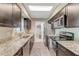 Updated kitchen with granite countertops, stainless steel appliances, and dark cabinetry at 1719 Anniston Ave, Daytona Beach, FL 32117