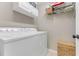Functional laundry room with washer, dryer, shelving, and storage baskets at 1719 Anniston Ave, Daytona Beach, FL 32117