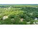 Home nestled in a wooded area, featuring a beautiful landscape with lush greenery and mature trees at 2270 Wilmhurst Rd, Deland, FL 32720