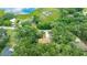 Aerial view of home surrounded by lush trees and a glimpse of a lake nearby at 2270 Wilmhurst Rd, Deland, FL 32720