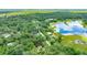 Home among a dense forest, adjacent to a beautiful lake, offering privacy and serene natural views at 2270 Wilmhurst Rd, Deland, FL 32720