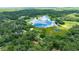 Panoramic aerial view of a home near a beautiful lake, surrounded by verdant trees and landscape at 2270 Wilmhurst Rd, Deland, FL 32720