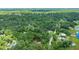 The home is nestled in a wooded area with mature trees and nearby lake and is surrounded by greenery at 2270 Wilmhurst Rd, Deland, FL 32720