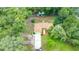 An aerial shot reveals a home nestled among trees, showcasing the home's long driveway at 2270 Wilmhurst Rd, Deland, FL 32720
