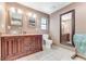Dual vanity bathroom with bowl sinks, framed mirrors, tile floors, and separate toilet area at 2270 Wilmhurst Rd, Deland, FL 32720