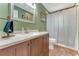 Traditional bathroom with granite countertops, wood cabinets, and tiled floors at 2270 Wilmhurst Rd, Deland, FL 32720