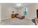 Cozy bedroom features neutral carpet, ceiling fan, and natural light from a window at 2270 Wilmhurst Rd, Deland, FL 32720