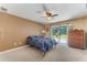 Spacious bedroom with ceiling fan, dresser, and sliding glass doors to the backyard at 2270 Wilmhurst Rd, Deland, FL 32720