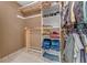 Walk-in closet features custom shelving, hanging rods, and a variety of clothing items at 2270 Wilmhurst Rd, Deland, FL 32720