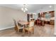 Open dining area with hardwood floors, wood table and chairs, and kitchen access at 2270 Wilmhurst Rd, Deland, FL 32720