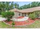 Charming one-story brick home featuring a front entrance with landscaped flower beds and brick accents at 2270 Wilmhurst Rd, Deland, FL 32720