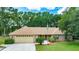 Charming one-story brick home featuring a well-manicured lawn and an attached two-car garage at 2270 Wilmhurst Rd, Deland, FL 32720