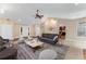 Inviting living room with vaulted ceilings, cozy seating, and view into the adjacent kitchen at 2270 Wilmhurst Rd, Deland, FL 32720