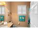 Well lit bathroom with stone countertops, and tiled shower at 3160 Bailey Ann Dr, Ormond Beach, FL 32174