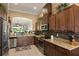 Spacious kitchen with dark cabinets, granite countertops, and stainless steel appliances at 3160 Bailey Ann Dr, Ormond Beach, FL 32174