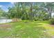 Expansive backyard featuring well-maintained lawn, privacy fencing, and mature trees at 7686 Sw 81St St, Ocala, FL 34476