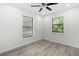 Bright bedroom with two windows and a ceiling fan at 7686 Sw 81St St, Ocala, FL 34476