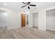 Neutral bedroom boasts wood-look flooring, two closets, and a glimpse of the bathroom at 7686 Sw 81St St, Ocala, FL 34476