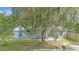 Inviting single-story home with mature trees, landscaped yard, and a driveway at 7686 Sw 81St St, Ocala, FL 34476