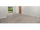 An airy living room featuring new hardwood floors, fresh paint, sliding glass door and wood door at 7686 Sw 81St St, Ocala, FL 34476
