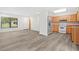 Open-concept living space with gray flooring, white walls, and a view of the kitchen at 7686 Sw 81St St, Ocala, FL 34476