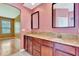 Bathroom with granite countertops, double sinks, and access to bedroom at 902 Heron Point Cir, Deland, FL 32724