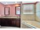 Bathroom featuring granite countertops, double sinks, and large soaking tub at 902 Heron Point Cir, Deland, FL 32724